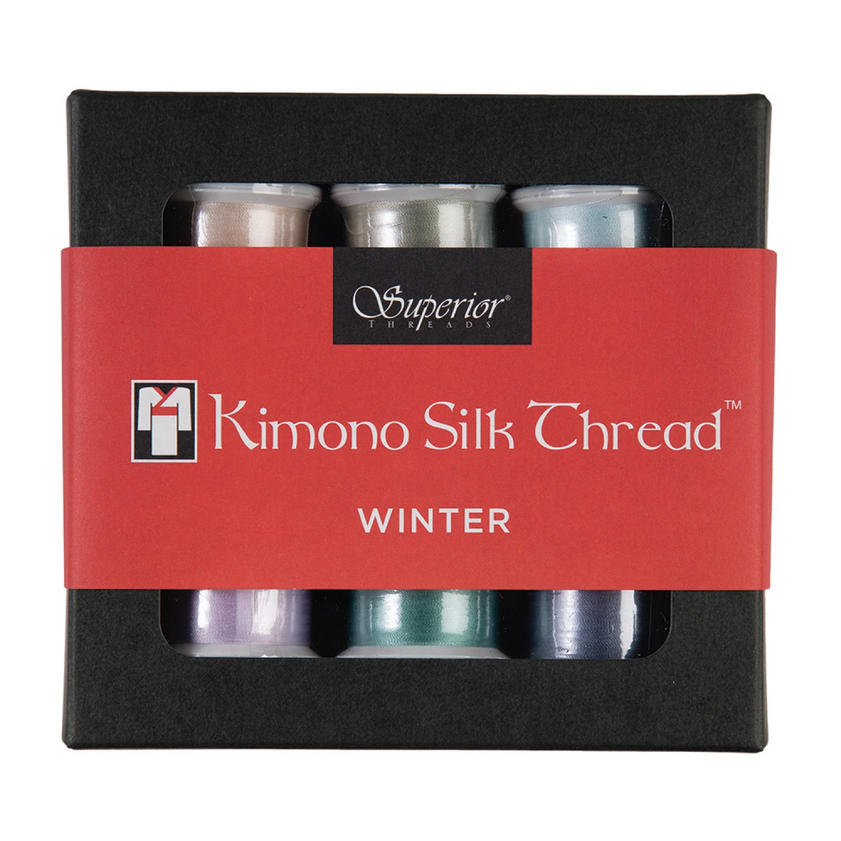 A set of six kimono silk thread spools in the 'Winter' colorway, presented in a black box with a red paper band. The spools show a mix of pastel colors including purple, teal, and silver.