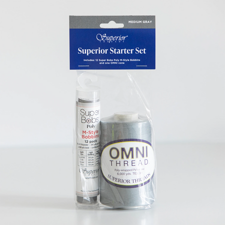Superior Threads Superior Starter Set containing a 12-pack of Super Bobs Pully M-Type Bobbin thread and a spool of OMNI THREAD in medium gray, packaged in a clear plastic bag with a blue header card.