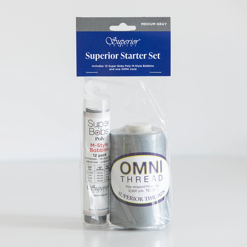 Superior Threads Superior Starter Set containing a 12-pack of Super Bobs Pully M-Type Bobbin thread and a spool of OMNI THREAD in medium gray, packaged in a clear plastic bag with a blue header card.