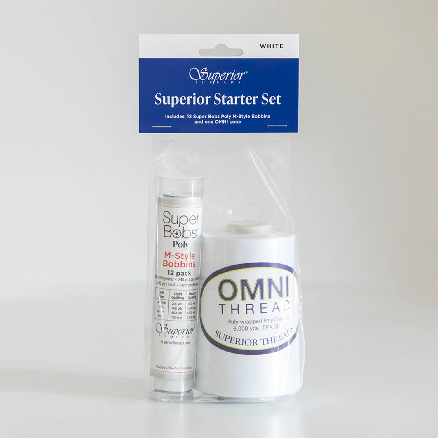 Superior Starters Set in clear plastic packaging with a blue and white header card. The set includes a spool of white Omni Thread and a tube of Superior Bobbins.