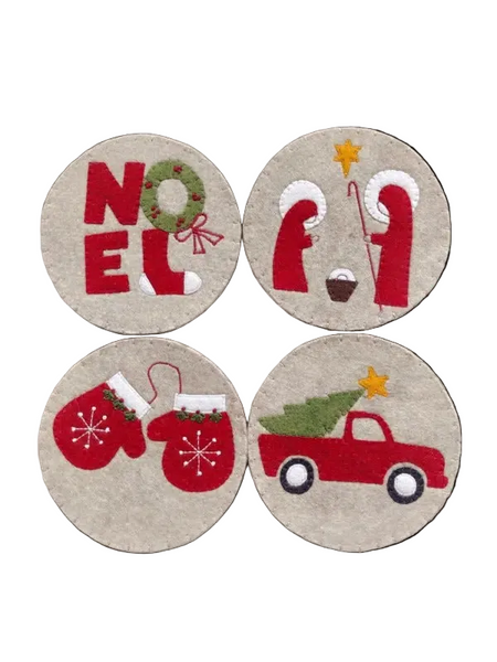 Four round Christmas-themed coasters with designs including 'NOEL', a nativity scene, mittens, and a red truck.