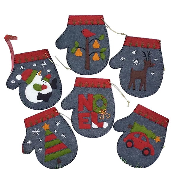 A set of charcoal gray mittens Christmas ornament kits with various festive appliques such as a partridge in a pear tree, a snowman, and a reindeer. The mittens have red cuffs and are decorated with embroidery floss and gold string.