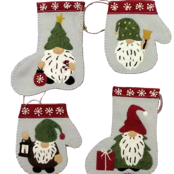 Four felt Christmas stocking ornaments with gnome designs, arranged on a purple measuring grid background. The stockings are light gray with red bands decorated with white snowflakes, and each gnome has a green hat, white beard, and different colored accents.