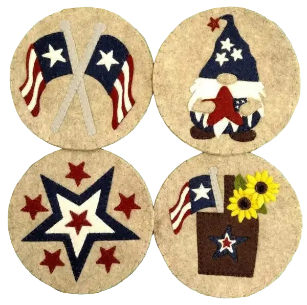 Four round embroidered patches featuring American flags, stars, and a gnome on a green cutting mat.
